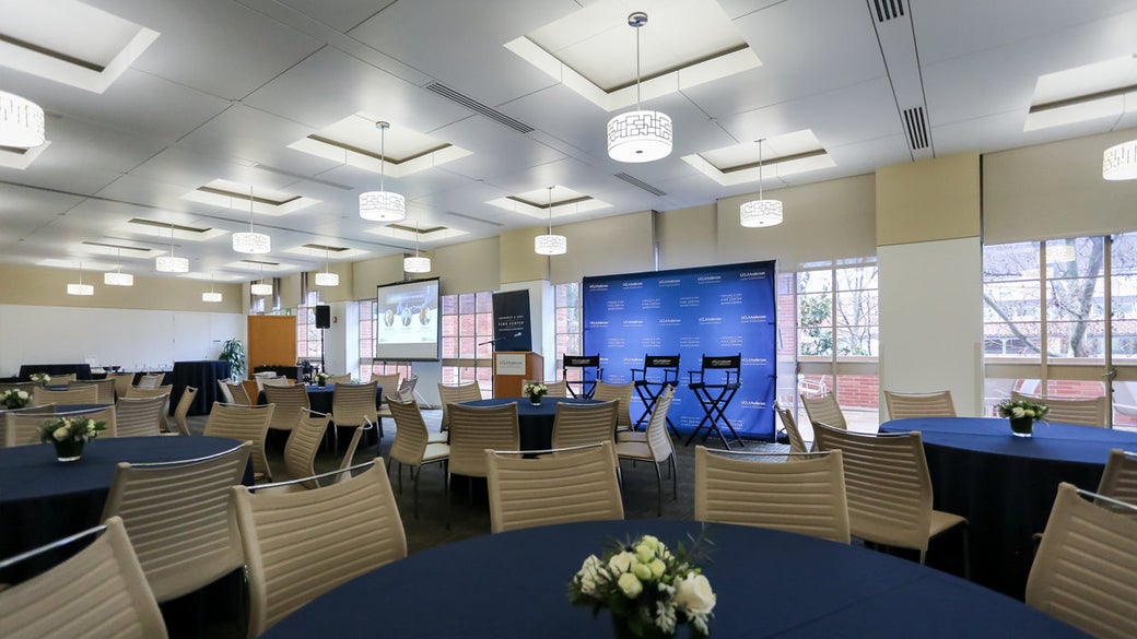 Empty Executive Dining Room prepared for an event with 3 director chairs on a stage