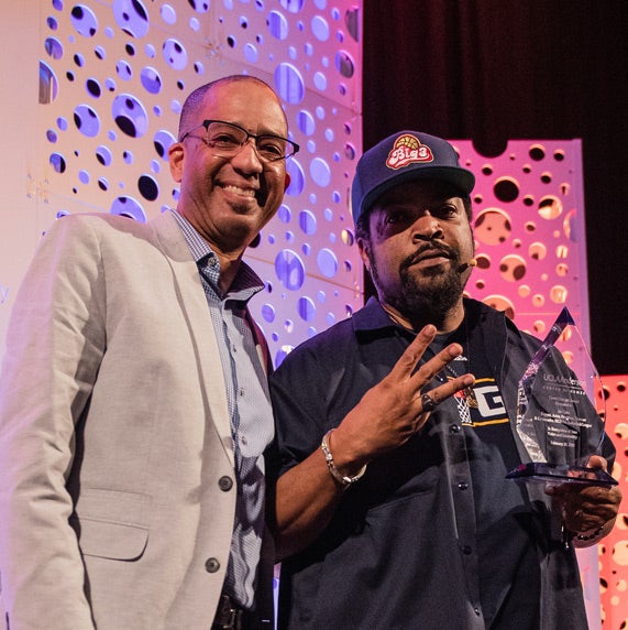 Rapper Ice Cube receiving an award with Jay Tucker