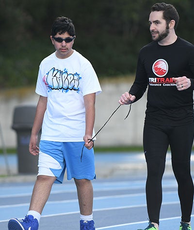 Visually impaired athlete training on a race track