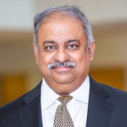 Professor Kumar Rajaram in dark suit and tie