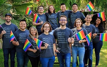 LGBTQ Students holding Pride flags