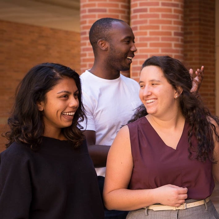Three students smiling at the Anderson Courtyard