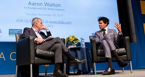 Dean Tony Bernardo and Aaron Walton seated and having a conversation on stage at an event