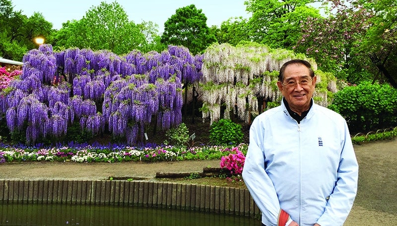 Dr. Hsieh in front of a garden